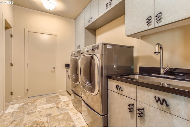 17907 SW Cicero Ct, Beaverton, OR 97007 - laundry room featuring washing machine and clothes dryer, cabinet space, and stone tile flooring