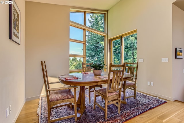17907 SW Cicero Ct, Beaverton, OR 97007 - dining room featuring light wood finished floors and a towering ceiling