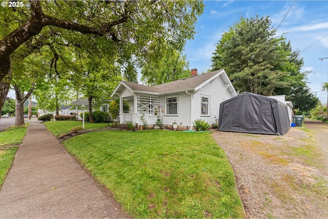 406 8th St, Springfield, OR 97477 - view of front of house with a front lawn, gravel driveway, a chimney, and a shingled roof