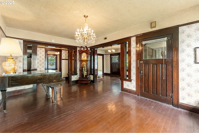 406 8th St, Springfield, OR 97477 - foyer entrance with wallpapered walls, a chandelier, a textured ceiling, wood-type flooring, and baseboards