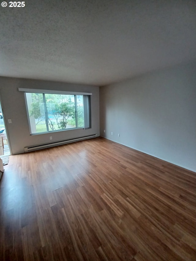 7720 SW Bel Aire Dr, Beaverton, OR 97008 - unfurnished room with a baseboard heating unit and wood finished floors
