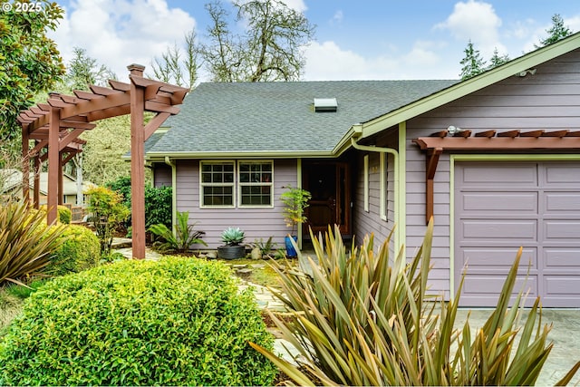 view of front of property featuring a pergola and a shingled roof