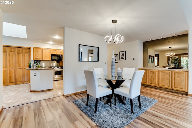 dining space featuring a chandelier, recessed lighting, and light wood-style flooring