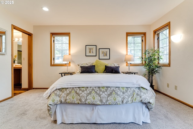 bedroom featuring multiple windows, baseboards, and carpet floors