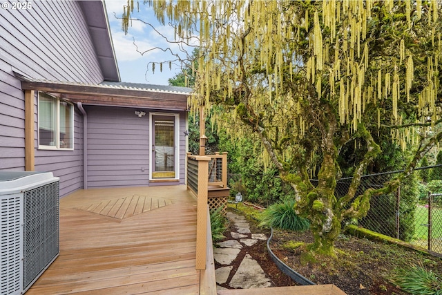 wooden terrace with central air condition unit and fence