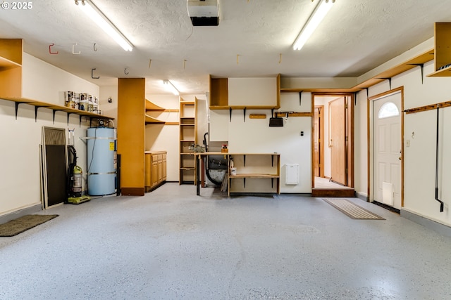 garage featuring secured water heater, a garage door opener, and baseboards