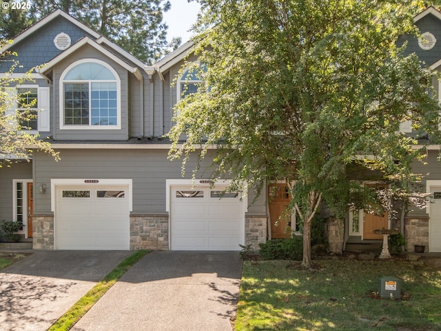 15320 SW Jasper Ln, Beaverton, OR 97007 - view of front of property featuring concrete driveway, stone siding, and a garage