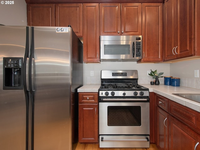 15320 SW Jasper Ln, Beaverton, OR 97007 - kitchen featuring stainless steel appliances and tile countertops
