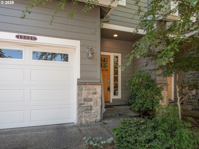 15320 SW Jasper Ln, Beaverton, OR 97007 - property entrance featuring a garage and stone siding