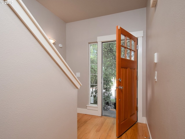 15320 SW Jasper Ln, Beaverton, OR 97007 - foyer entrance with light wood-style floors, baseboards, and stairs