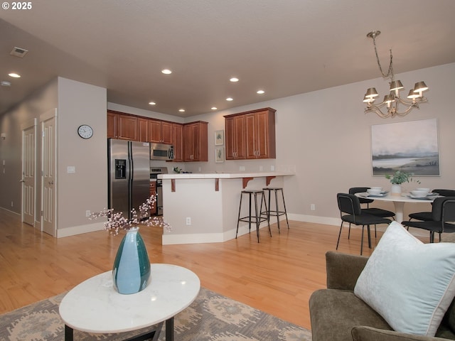 15320 SW Jasper Ln, Beaverton, OR 97007 - living area featuring a chandelier, light wood-type flooring, recessed lighting, and baseboards