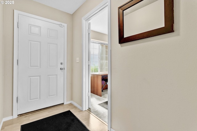 entrance foyer featuring baseboards and light wood-type flooring