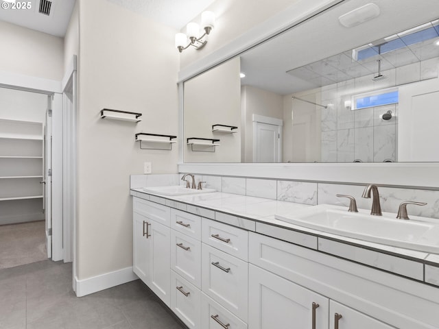 bathroom with vanity and tiled shower