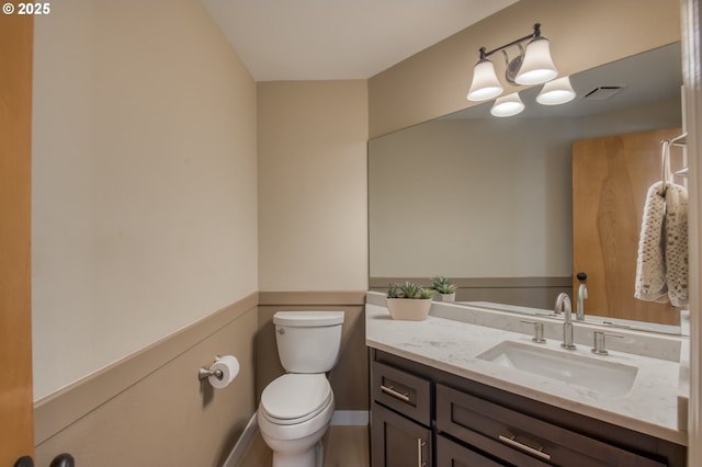 bathroom with toilet and vanity