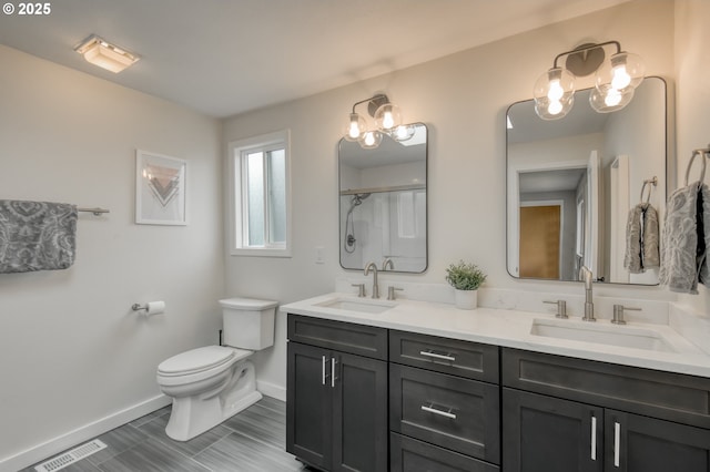 full bath featuring baseboards, toilet, double vanity, and a shower