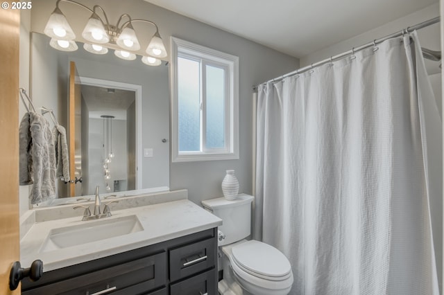 full bathroom featuring toilet, vanity, and curtained shower