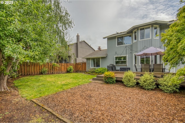rear view of house featuring a deck