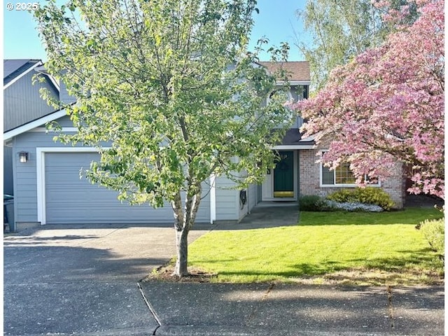 obstructed view of property with driveway, a front yard, and an attached garage