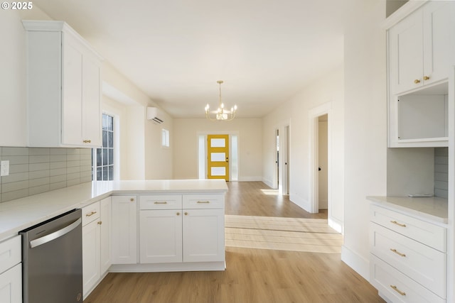 kitchen featuring white cabinetry, pendant lighting, light hardwood / wood-style flooring, and dishwasher