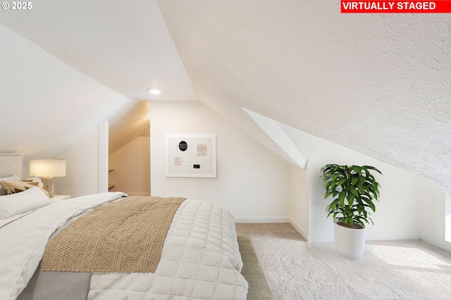 bedroom with light carpet and vaulted ceiling