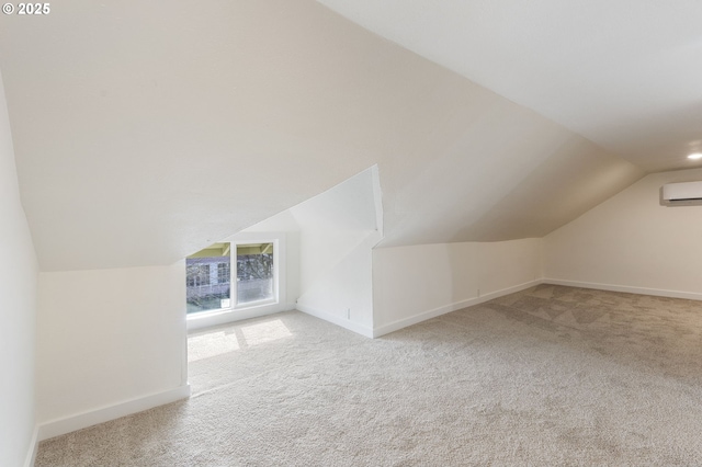 additional living space with lofted ceiling, light carpet, and a wall unit AC