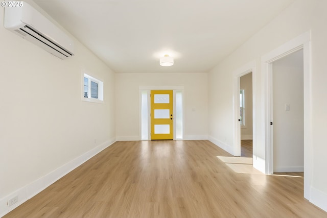 entrance foyer featuring light hardwood / wood-style floors and a wall mounted AC