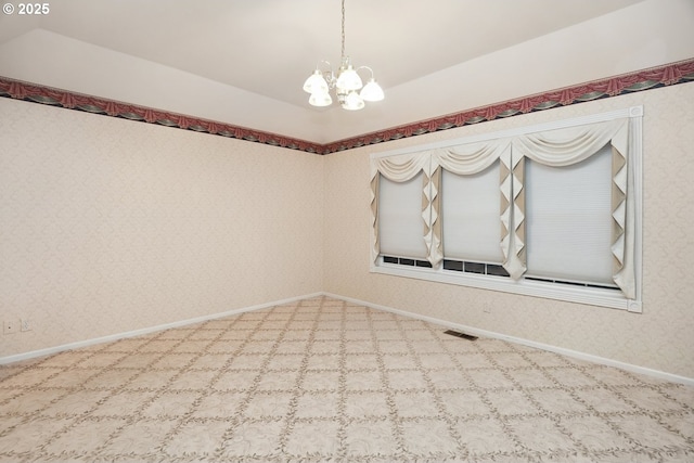 carpeted empty room featuring a chandelier, baseboards, and wallpapered walls