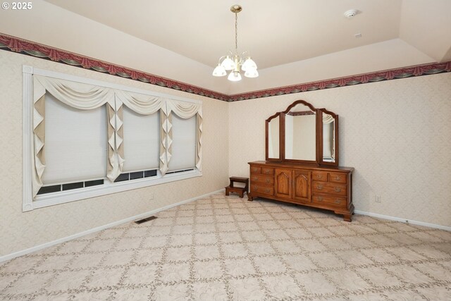unfurnished bedroom with a chandelier, carpet floors, baseboards, and wallpapered walls