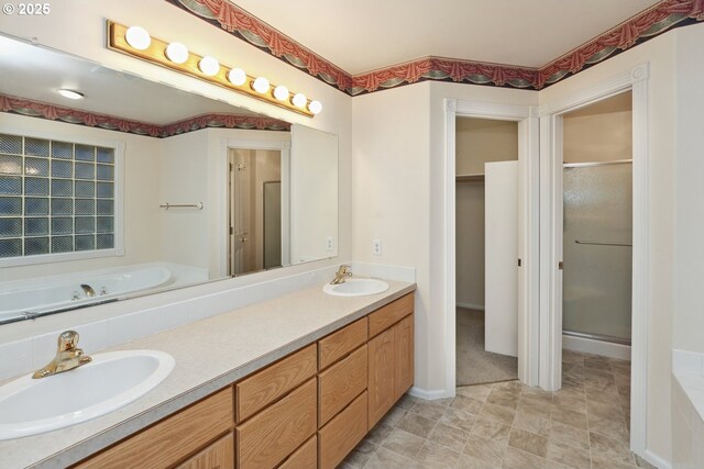 full bathroom featuring a shower stall, a garden tub, and double vanity