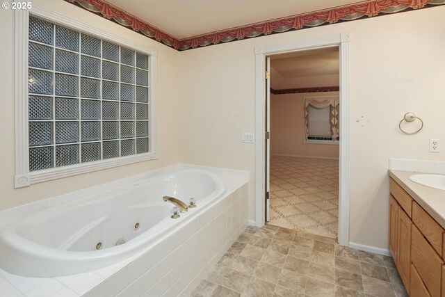 bathroom featuring vanity and a jetted tub