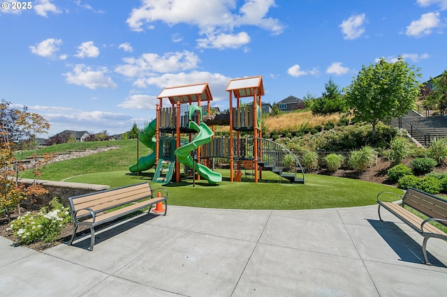 community jungle gym featuring a lawn