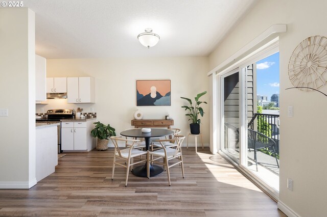 dining room with light wood-style floors and baseboards