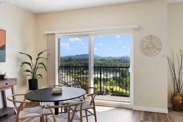 dining area with wood finished floors and baseboards