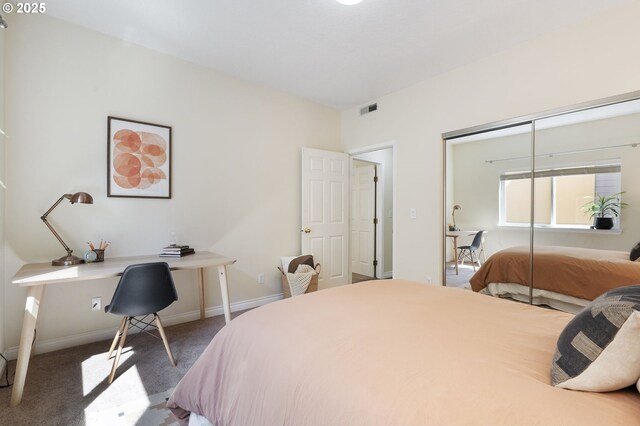 bedroom with a desk, carpet floors, a closet, and baseboards