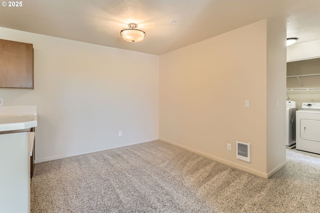unfurnished dining area featuring washing machine and dryer, carpet floors, and baseboards