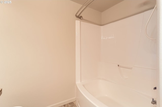 bathroom featuring baseboards and shower / washtub combination