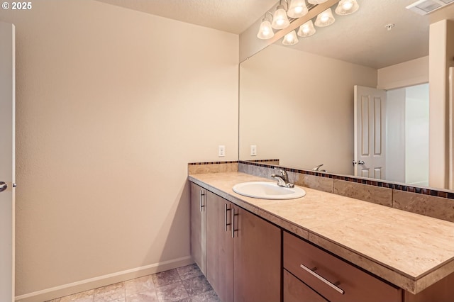 bathroom featuring baseboards and vanity
