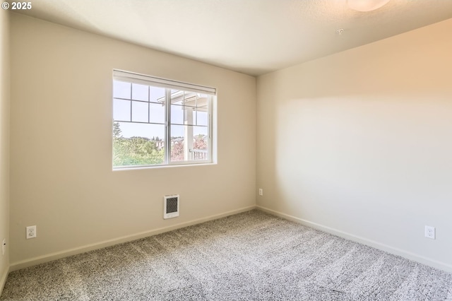 carpeted spare room featuring baseboards and heating unit