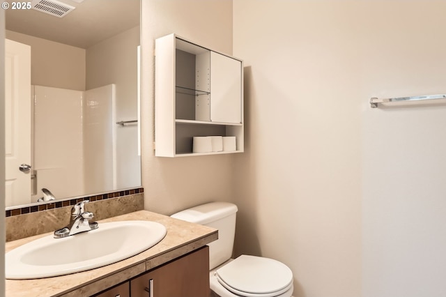 bathroom featuring toilet and vanity