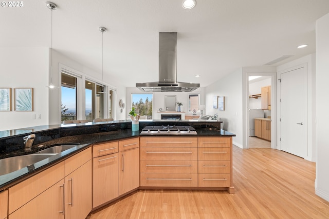 kitchen featuring pendant lighting, sink, stainless steel gas cooktop, exhaust hood, and light brown cabinets