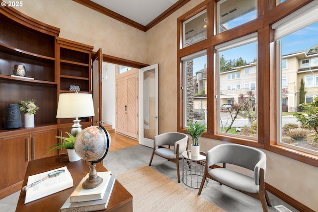 office space with ornamental molding and light wood-type flooring