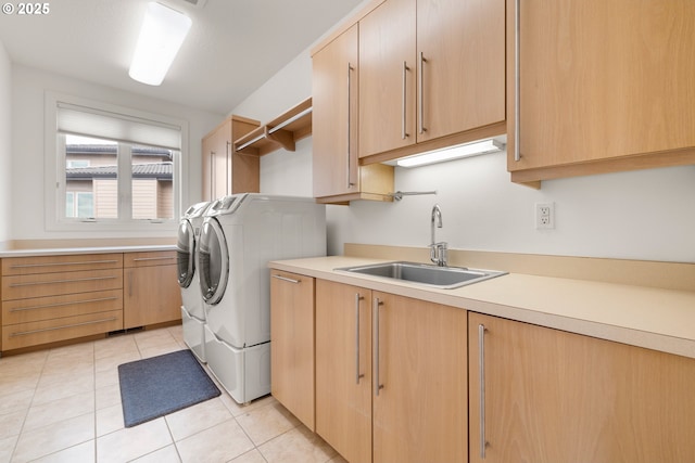 laundry room featuring cabinets, sink, light tile patterned floors, and independent washer and dryer