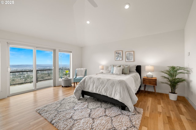 bedroom with access to outside, vaulted ceiling, ceiling fan, and light wood-type flooring