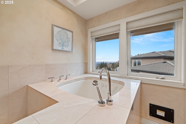 bathroom with a tub to relax in