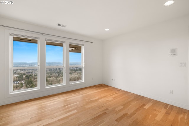 spare room with light hardwood / wood-style floors