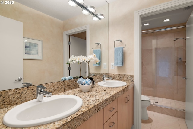 bathroom with tile patterned flooring, vanity, a shower with door, and toilet