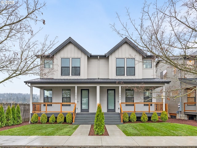 view of front of home featuring covered porch, board and batten siding, and a front lawn
