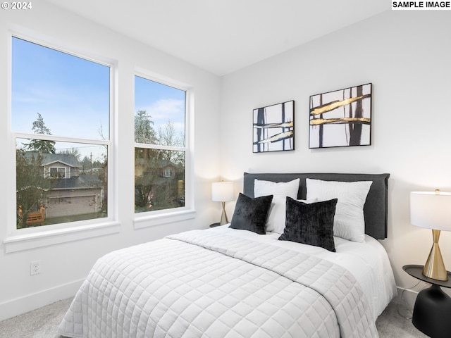 carpeted bedroom featuring baseboards