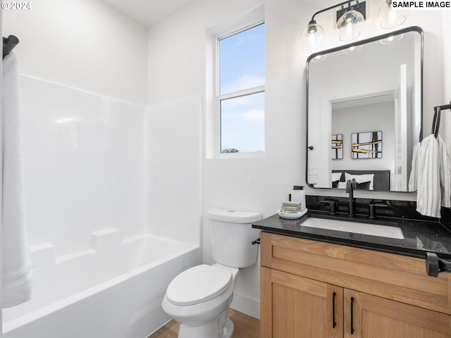 full bath featuring vanity, shower / bathtub combination, wood finished floors, and toilet