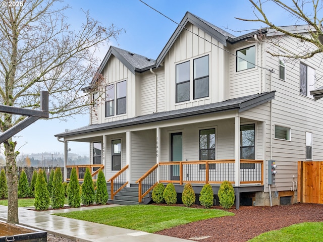 view of front of home featuring roof with shingles, board and batten siding, and a porch